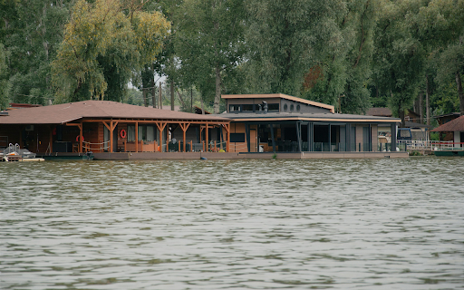 A house on the water with a dock and a tree from Chrome web store to be run with OffiDocs Chromium online A house on the water with a dock and a tree from Chrome web store to be run with OffiDocs Chromium online